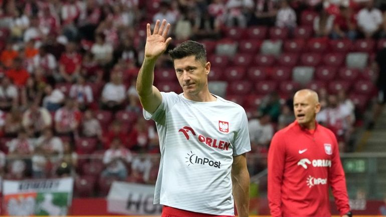 Poland's Robert Lewandowski greets supporters ahead the international friendly soccer...