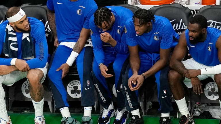 The Dallas Mavericks bench watches play during the second half...