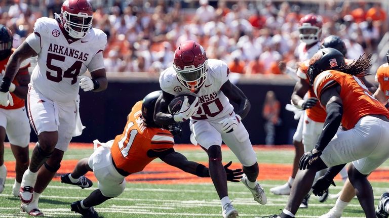 Arkansas running back Rodney Hill (20) runs past Oklahoma State...