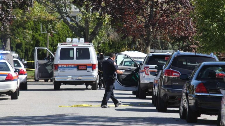 Nassau County police investigate the scene of a home invasion...