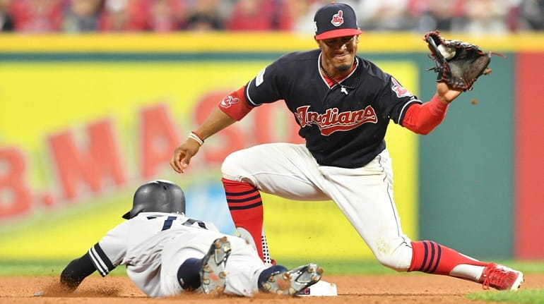 Cleveland Indians shortstop Francisco Lindor commits a fielding error on a  ground ball by New York Yankees' Ronald Torreyes with the bases loaded  during the fifth inning of a baseball game allowing