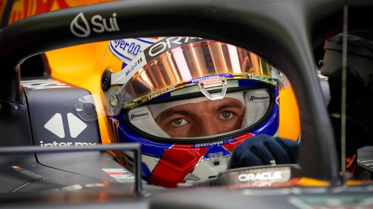 Red Bull driver Max Verstappen of the Netherlands sits in...