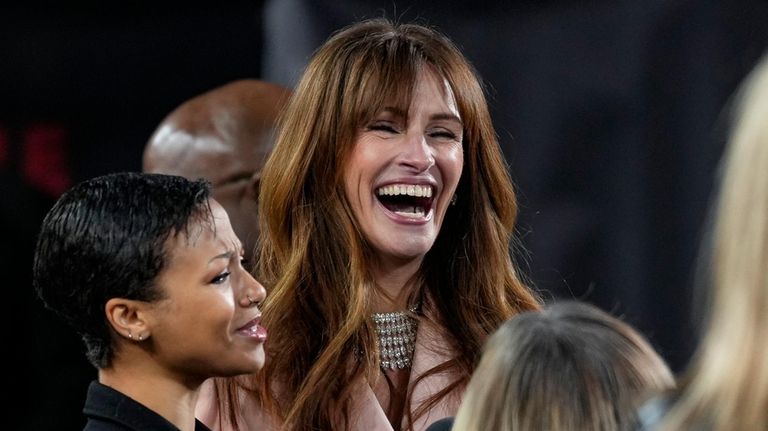 Myha'la Herrold, left, and Julia Roberts are interviewed upon arrival...