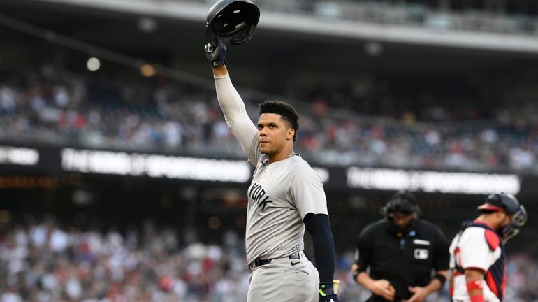 Yankees' Juan Soto doffs his batting helmet to the crowd...