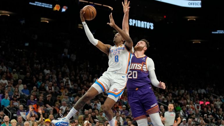 Oklahoma City Thunder forward Jalen Williams drives past Phoenix Suns...