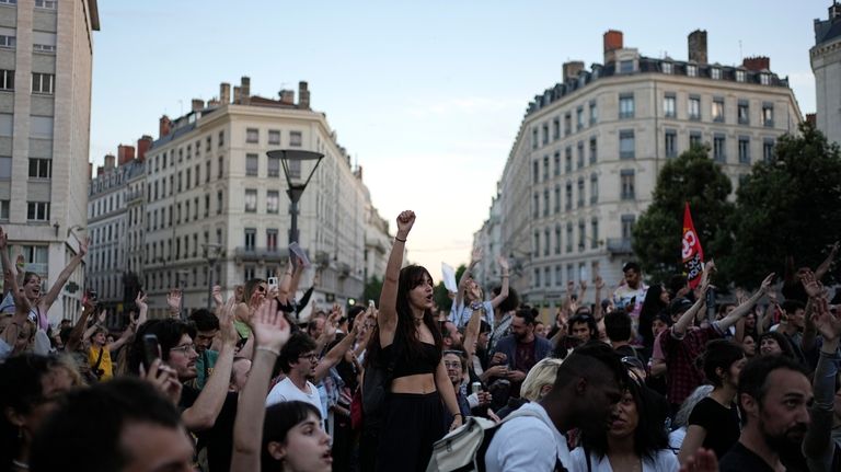 People stand in a square as they react to projected...