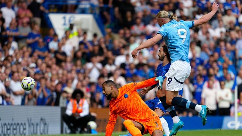 Manchester City's Erling Haaland scores his side's opening goal during...