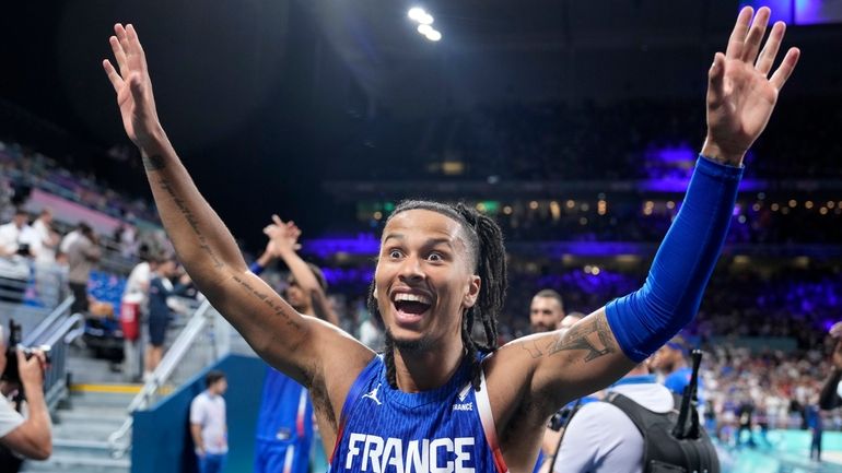 France's Matthew Strazel celebrates after France defeated Japan in a...