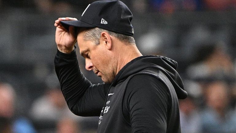 Yankees manager Aaron Boone walks to the dugout after a...