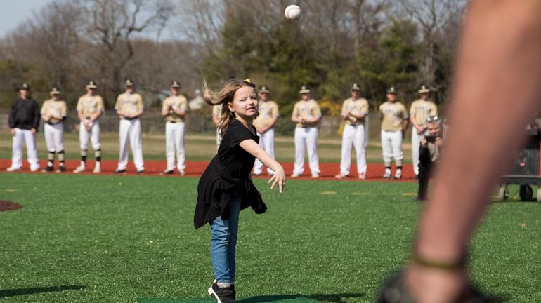 Ella Bonin, 5, throws the first pitch at the dedication of the...