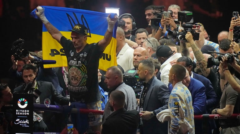 Ukraine's Oleksandr Usyk celebrates after beating Britain's Tyson Fury in...