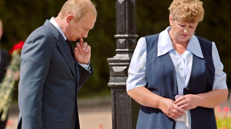 Russian Presdient Vladimir Putin, left, and Nadezhda Shakhatinina, mother of...