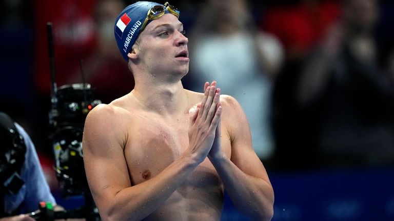 Leon Marchand, of France, reacts after winning the men's 200-meter...