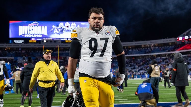 Pittsburgh Steelers defensive tackle Cameron Heyward (97) walks off the...