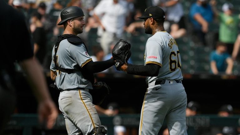 Pittsburgh Pirates closing pitcher Dennis Santana (60) celebrates with catcher...