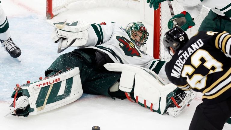 Minnesota Wild's Marc-Andre Fleury sprawls on the ice as Boston...