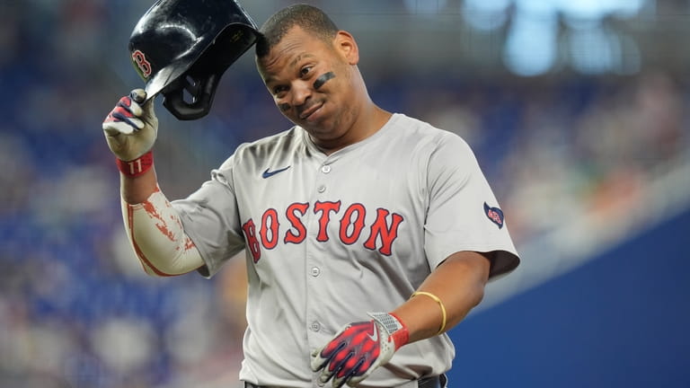 Boston Red Sox third baseman Rafael Devers gestures after he...