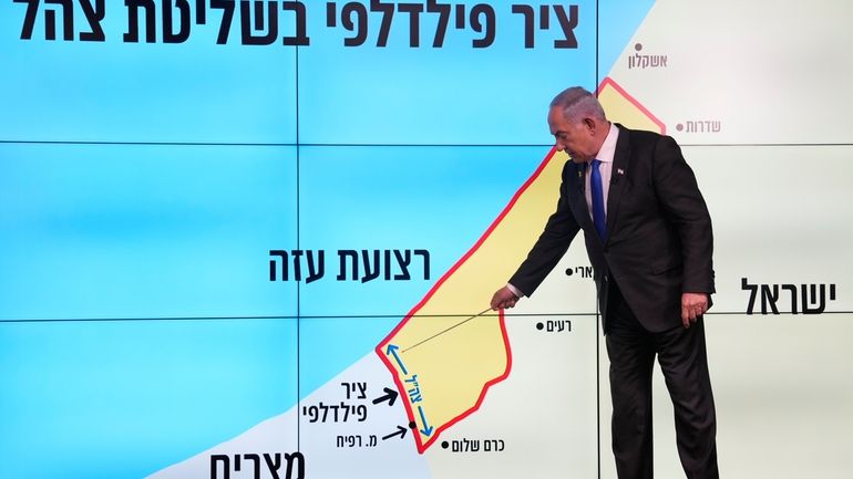 Israeli Prime Minister Benjamin Netanyahu stands before a map of...