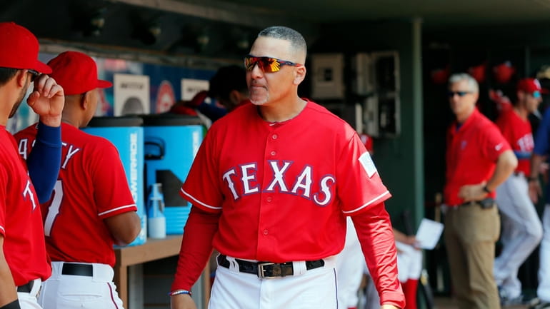 FILE -Texas Rangers first base coach Hector Ortiz (4) walks...