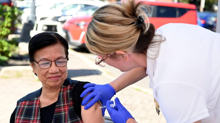 Feliciana Minsky, 74, of East Meadow receives a COVID vaccine...