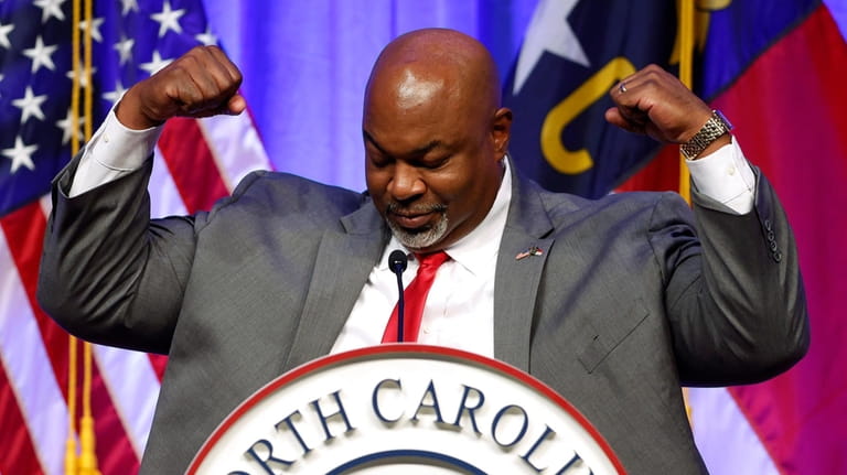 Lt. Gov. Mark Robinson flexes after telling the audience that...