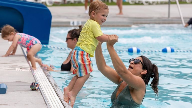 Alison Aquino, 33, of Sayville, participates in a swimming session with...