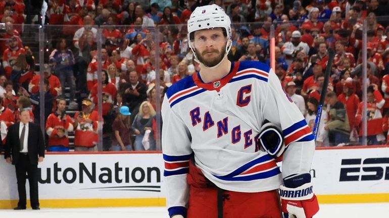 Jacob Trouba of the Rangers looks on after being defeated by the...