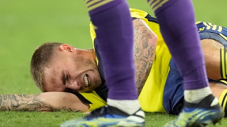 Nashville SC midfielder Tyler Boyd lies on the field injured...