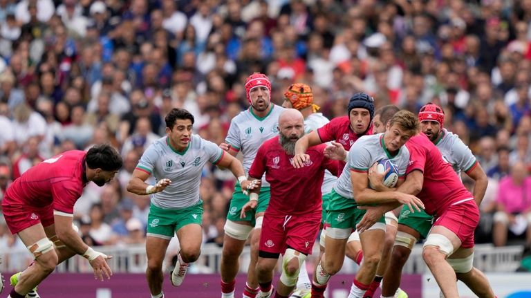 Portugal's Jeronimo Portela is challenged by Georgia's Konstantine Mikautadze, right,...