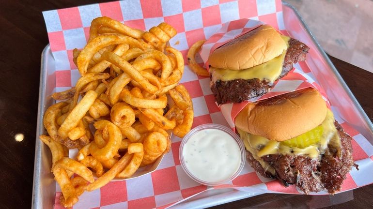 Single and double smashburgers with curly fries at BRGRS in Huntington.