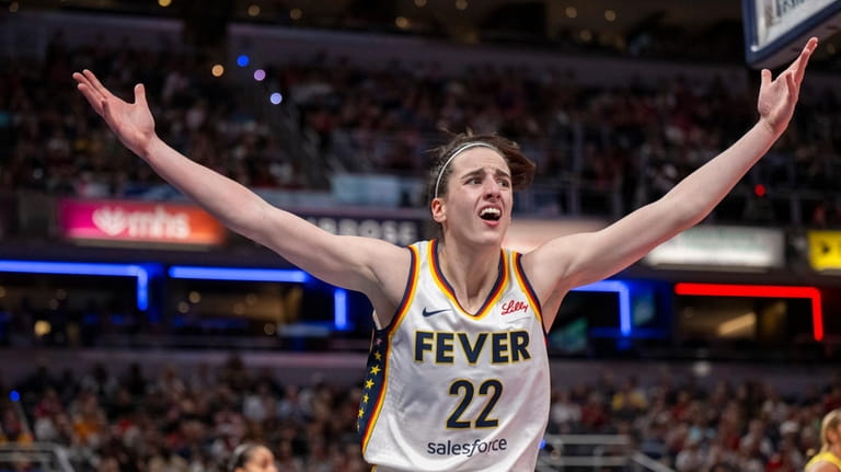Indiana Fever guard Caitlin Clark reacts after scoring against the...