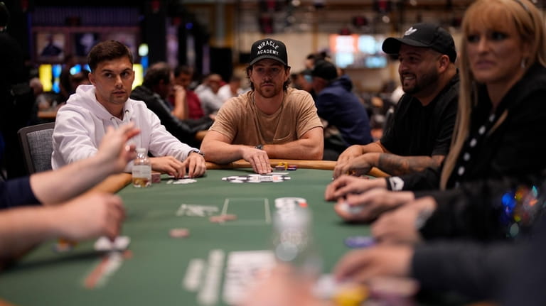 Vegas Golden Knights right wing Jonathan Marchessault, center, plays poker...
