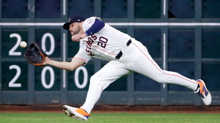 Houston Astros left fielder Chas McCormick makes a catch for...
