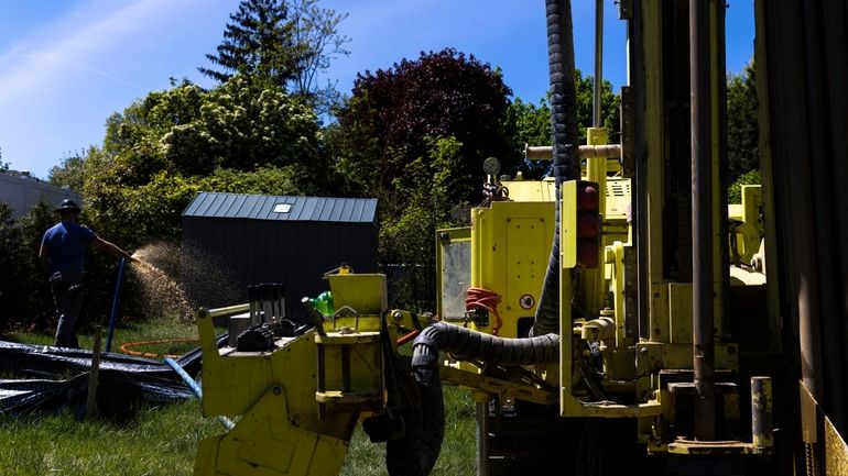 A Dandelion Energy employee sprays excess groundwater back on the...