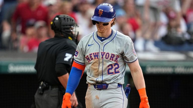 The Mets' Brett Baty walks back to the dugout after striking...