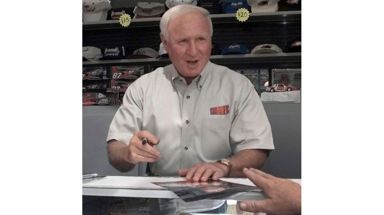 Cale Yarborough signs autographs for fans at Darlington Raceway Saturday,...