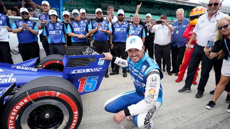 Graham Rahal celebrates after winning the pole for the IndyCar...