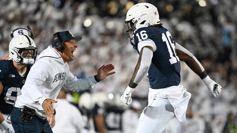 Penn State head coach James Franklin, left, celebrates with tight...