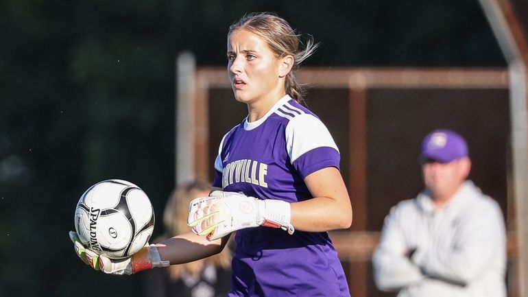 Sayville goalkeeper Olivia Moynihan looks to send the ball to...