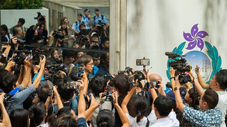 Member of the media surround Chung Pui-kuen, the ex-chief editor...