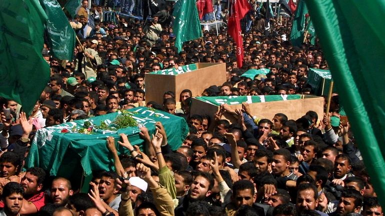 Thousands of Palestinian mourners carry the coffin of Hamas spiritual...