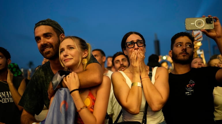 A woman weeps at the Nova Healing Concert in Tel...