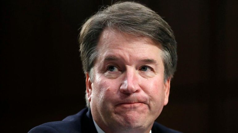 Supreme Court nominee Brett Kavanaugh reacts as he testifies after...