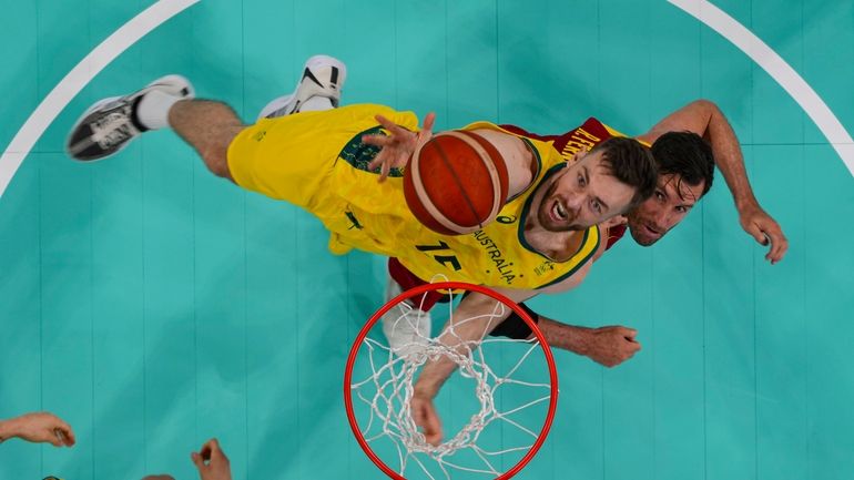 Nick Kay, of Australia, shoots over Rudy Fernández, of Spain,...