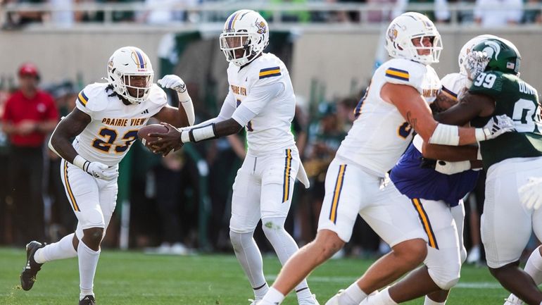 Prairie View A&M quarterback Cameron Peters hands off to a...