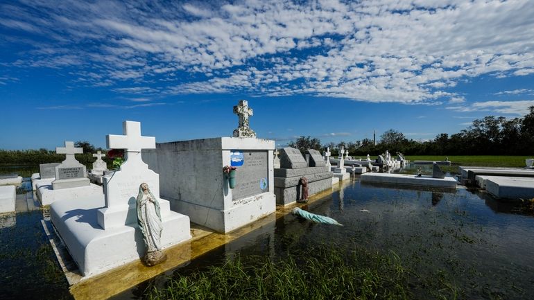 Tombs are seen after being disturbed by flooding, in the...