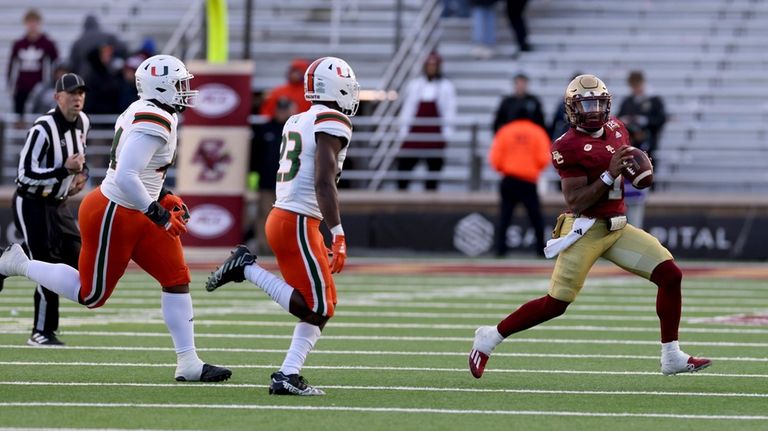 Boston College quarterback Thomas Castellanos (1) runs the ball ahead...