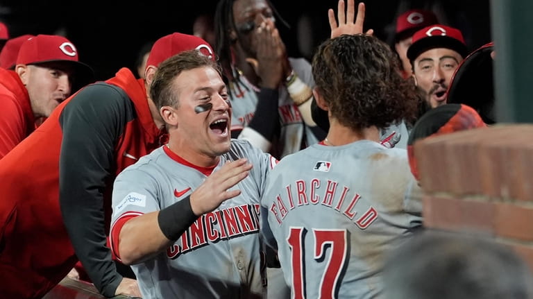 Cincinnati Reds' Stuart Fairchild (17) is congratulated by teammates after...