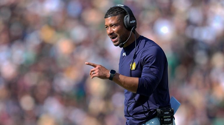 Notre Dame head coach Marcus Freeman gestures after a touchdown...