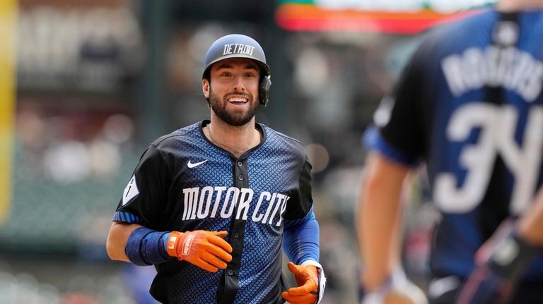 Detroit Tigers' Matt Vierling is greeted at home plate after...